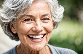 Close-up portrait of smiling senior woman with dentures