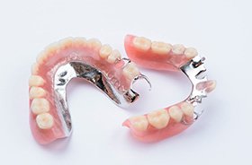 Two partial dentures against neutral background