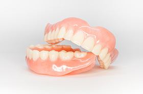 Full set of dentures displayed against neutral background