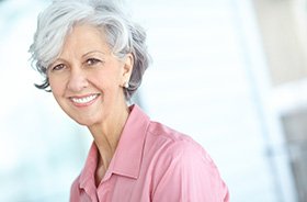 Smiling older woman in pink blouse