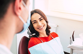 Happy patient talking to dentist