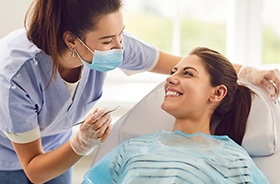 Happy patient looking at dental team member