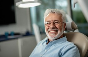 Smiling senior dental patient in treatment chair