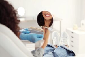 Cosmetic dentistry patient looking at her smile in the mirror